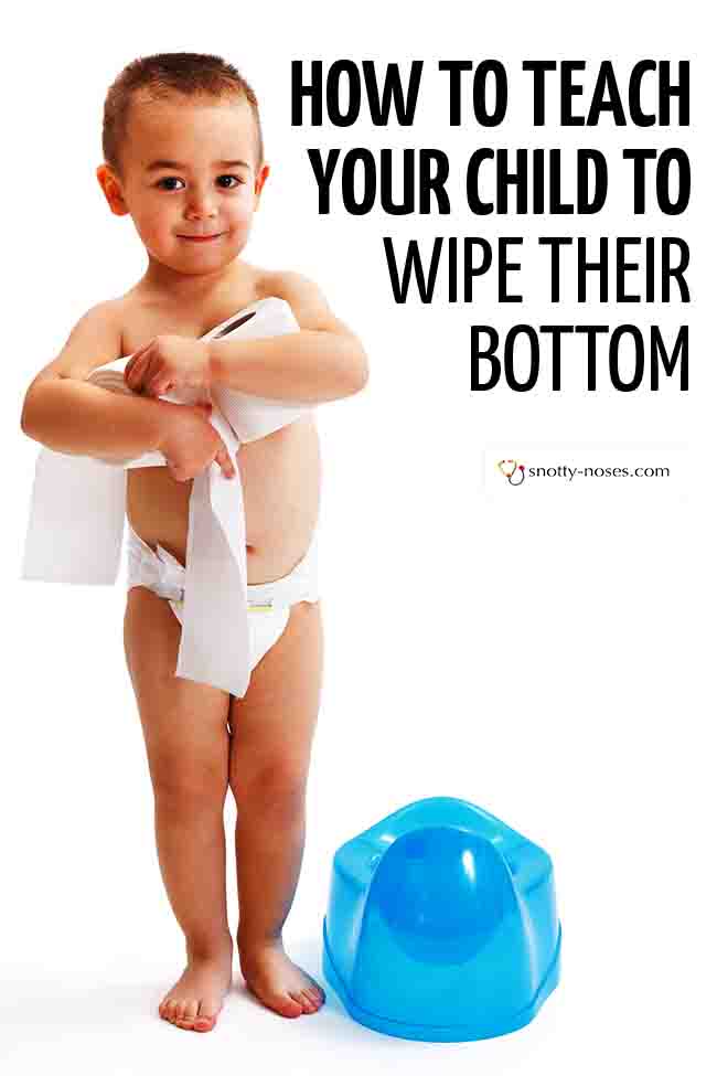 A little boy standing up with a diaper on, holding some rolls of toilet paper (learning to wipe his bottom). Standing next to a blue potty. #parenting #toddler #wipebottom #toilettraining #pottytraining #toiletingkid