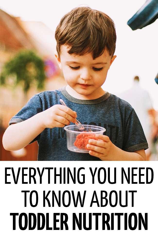 A toddler eating a portion of healthy ice cream in a plastic cup. Everything you need to know about toddler nutrition!